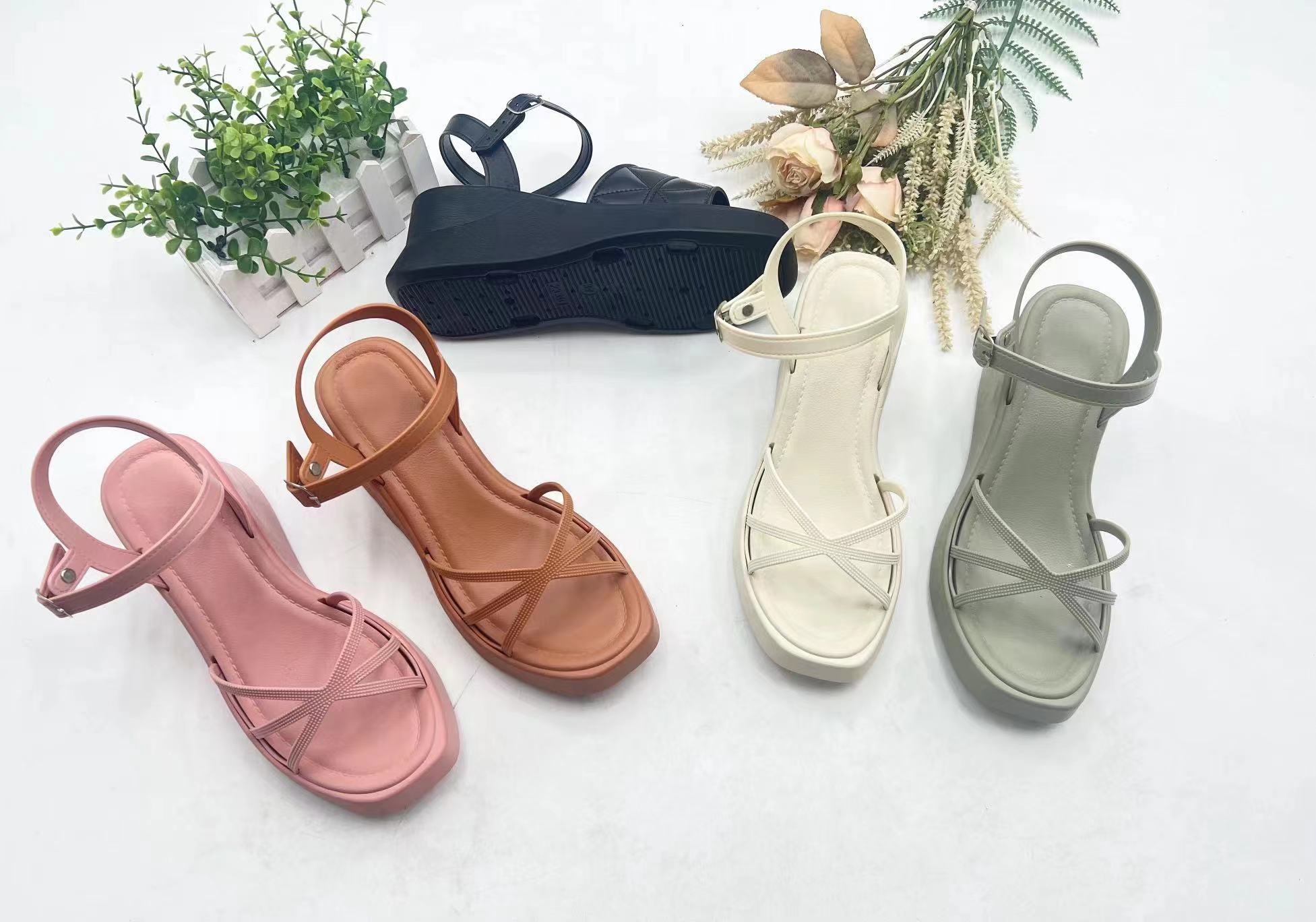 Assorted slippers and sandals of various designs and colors arranged on display shelves, modern retail presentation